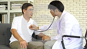Asian Senior man checkup by doctor use stethoscope listening heartbeat