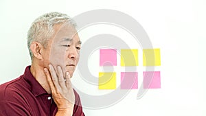 Asian senior man expression worry note paper. copy space