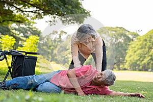 Asian senior man falling down from wheelchair on lying floor after trying push the wheelchair forward and Crying in pain and