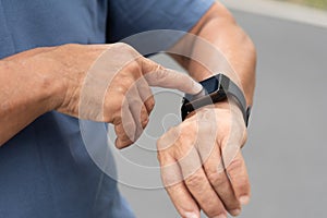 Asian senior man hands checking his heartbeat with smart watch