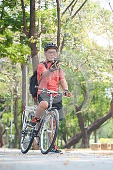 Asian Senior man in helmet holding mobile phone and taking selfie