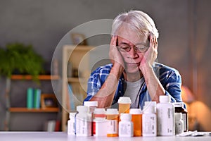 Asian senior man with his medicine bottles