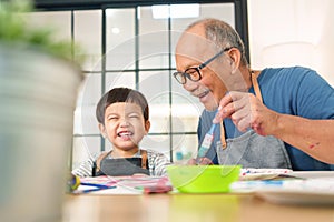 Asian Senior man and little boy Enjoying painting