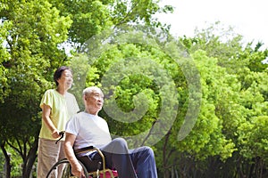 Asian senior man sitting on a wheelchair with his wife