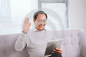 Asian senior man with tablet pc computer make video call