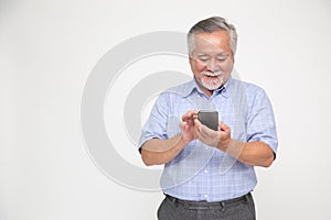 Asian senior man using smartphone isolated over white background.