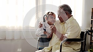 Asian Senior man was sick and sitting on wheelchair. Retirement age lifestyle and togetherness with family at home