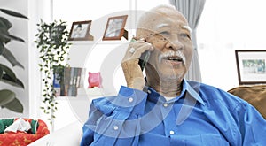 Asian Senior man with white mustache talking with smart phone