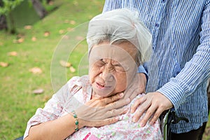 Asian senior mother have nerve pain,shoulder and neck pains,female caregiver or daughter massaging her shoulders elderly woman,