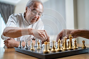 Asian Senior Old male spend leisure time, stay home after retirement. Happy smiling Elderly man enjoy activity in house playing