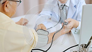 Asian senior patient having medical exam with doctor in hospital