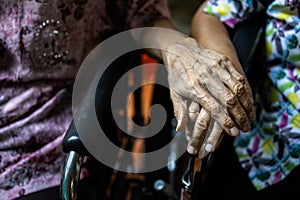 Asian senior people and old friends in wheelchair,holding hands to encourage each other in times of discouragement and despair,