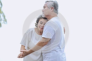 Asian senior retired couple, relax smiling elder man and woman enjoying with retired vacation at sea beach outdoor. Health