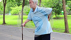 Asian senior woman with back and hip joint painful while walking exercise,female patient have backache,lumbago pain,hand touch on