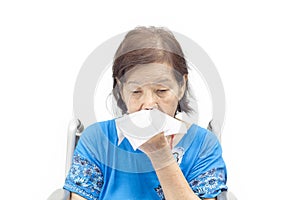 Asian senior woman blowing her nose