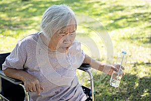 Asian senior woman choking on water,elderly people with poor quality water,bad smell and dirty of water, smelled plastic causing