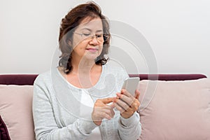 Asian senior woman looking through her contacts