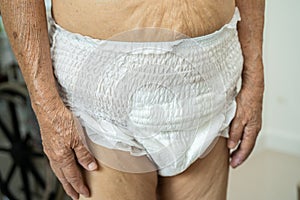 Asian senior woman patient wearing incontinence diaper in hospital, healthy strong medical concept