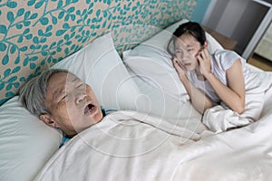 Asian senior woman snoring loudly open mouth comfortably sleeping danger of obstructive sleep apnea disease stressed child girl