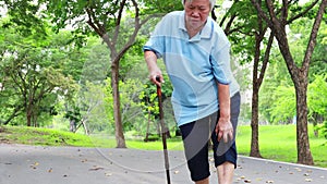 Asian senior woman suffer from arthritis, osteoarthritis,elderly people walking,holding hand on the knee,feeling pain in the knee