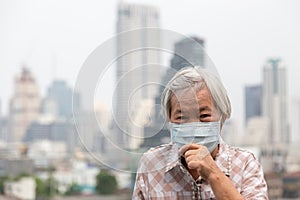 Asian senior woman suffer from cough with face mask protection,elderly woman wearing face mask because of air pollution in the