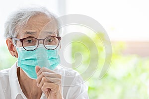 Asian senior woman suffer from cough with face mask protection,elderly woman wearing face mask because of air pollution,Sick old photo