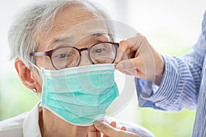 Asian senior woman suffer from cough with face mask protection,elderly woman wearing face mask because of air pollution,Sick old