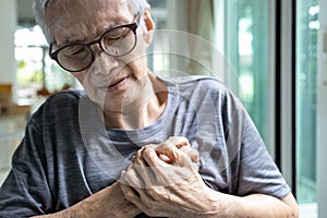 Asian senior woman touching her chest,heart attack,female elderly clutching chest pain,angina pectoris disease,old people
