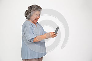 Asian senior woman using smartphone isolated over white background.