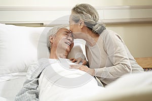 Asian senior woman visiting husband in hospital