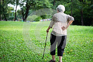 Asian senior woman wearing back support belt for protect her back pain,muscle injury,elderly people hand touching on the hip