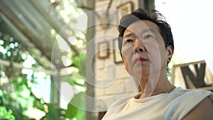 Asian senior woman worry sigh thinking at home