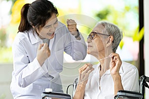 Asian senior woman listen,study how to use dental floss with professional female dentist,service or educate about oral health care