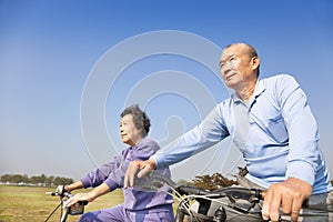 Asian seniors couple biking