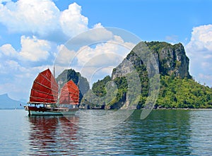 Exotic asian ship with red sails photo