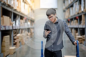 Asian shopper checking shopping list in warehouse