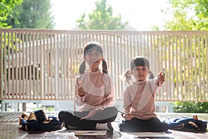 Asian sibling children drawing and painting colouring on the paper