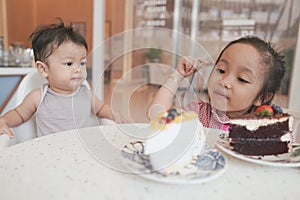 Asian sibling enjoying their desserts