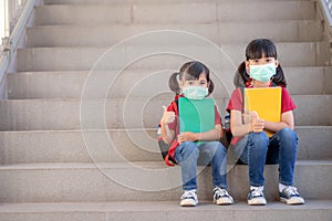 Asian sibling with face mask going back to school after covid-19 quarantine and lockdown