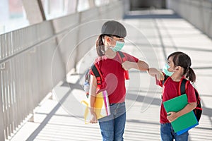 Asian sibling with face mask going back to school after covid-19 quarantine and lockdown