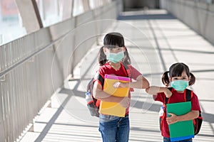 Asian sibling with face mask going back to school after covid-19 quarantine and lockdown