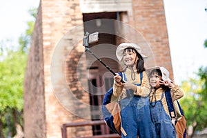 Asian sibling girls taking selfies. taking selfie photos with a smartphone