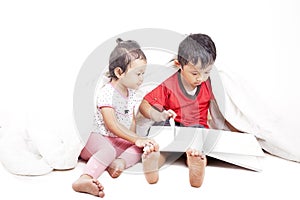 Asian siblings reading book