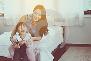 Asian single mom ticklish and carrying her cheerful daughter at home,Happy and funny