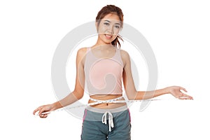 Asian slim girl measuring her waist with tape
