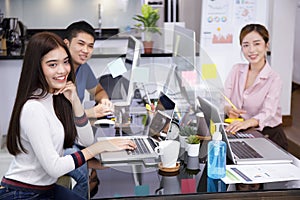 Asian small business startup multiracial working with laptop and  PC. Group of smiling asian people teamwork work from Private