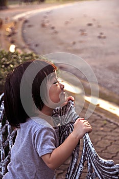 Asian small girl directs a smile to family