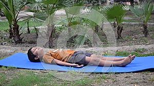 Asian smart kid doing yoga pose in the society park outdoor, Children's yoga pose. The little boy doing Yoga and meditation