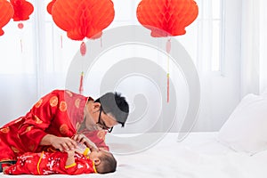 Asian smart young father feed his adorable son baby in bed  healthy fatherhood happy play with infant while feeding both father