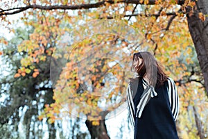Asian female in autumn nature with black dressing
